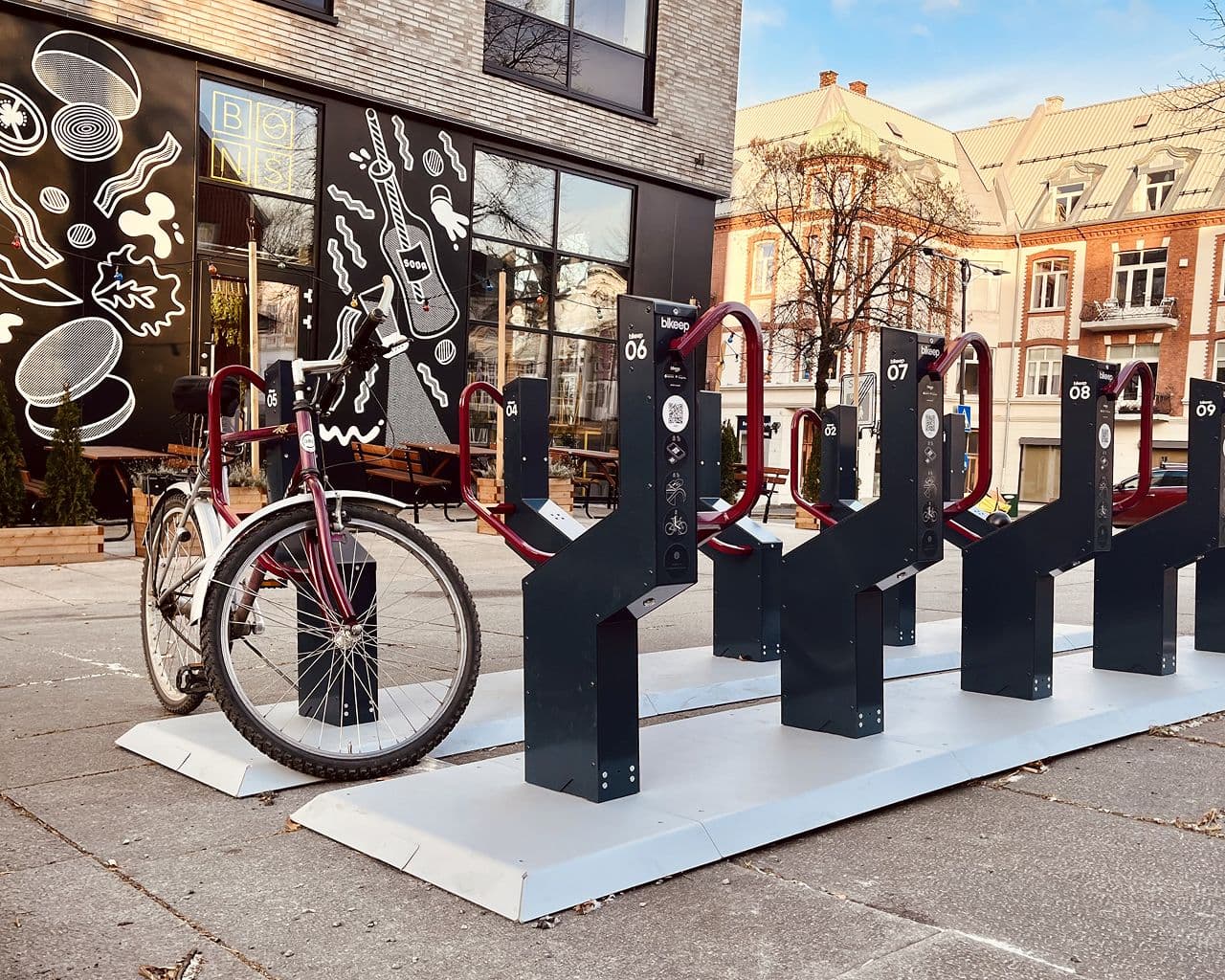 Co-branded Bikeep station with dark red locking bars